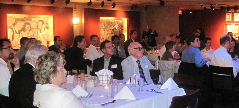 People sitting listening to a speaker.